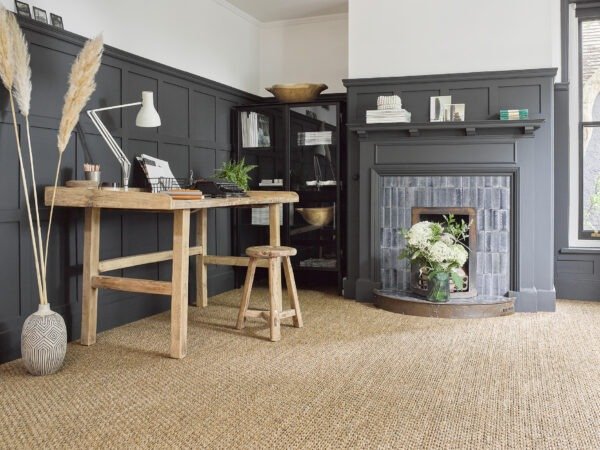 Natural sisal flooring fitted in a study with a fireplace
